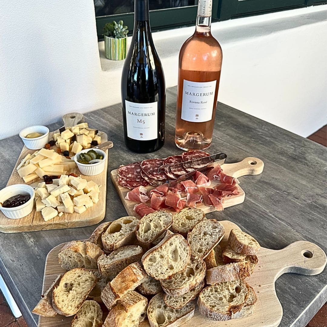 table spread with a delicious charcuterie and cheese board with wine table spread with a delicious charcuterie and cheese board with wine